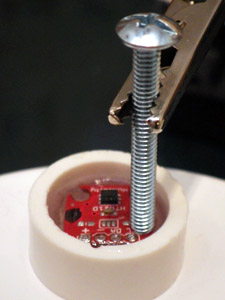  The wires of the housing pass-through always push the boards into odd angles, so I level the boards with a preliminary 'underlayer" of cured epoxy while applying some top pressure with a pin to hold things in place